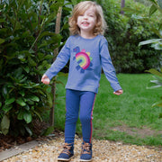 Girl in rainbow-saurus shirt